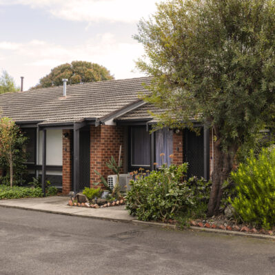 Two adjoining brick units, each with a small garden out the front.