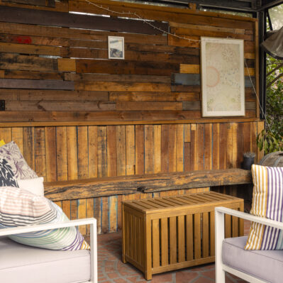 Undercover area featuring comfy outdoor seating, coffee table and a garden.