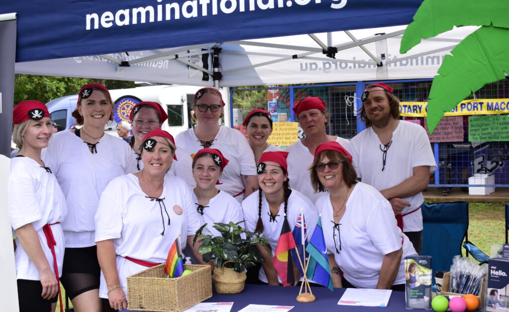 The Neami Mid North Coast team smile together wearing matching pirate costumes.