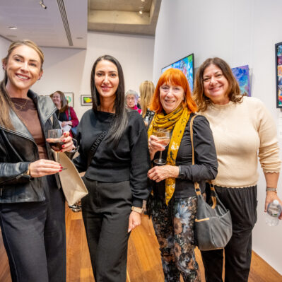 People facing the camera, standing in gallery.