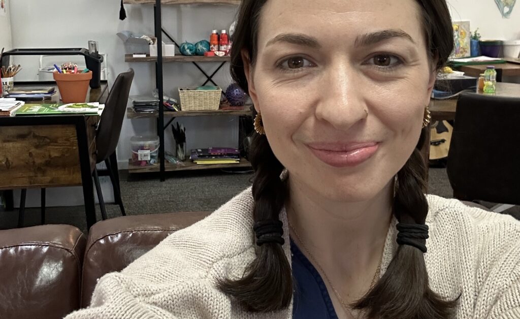 Zoe is pictured smiling to camera.