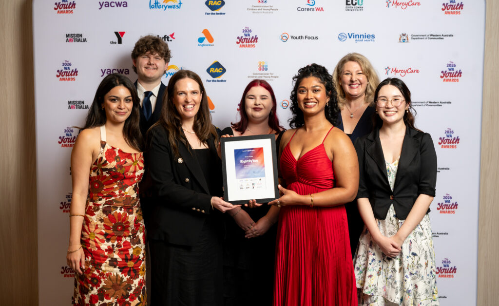 Neami staff and RightByYou youth ambassadors smile together holding their WA Youth Awards nomination.